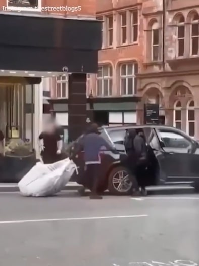 Footage shows two men wearing balaclavas getting into a BMW