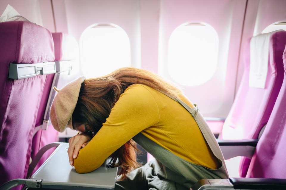 A study has found that you should lean forward if you want to sleep on a flight - and not the window (stock image)