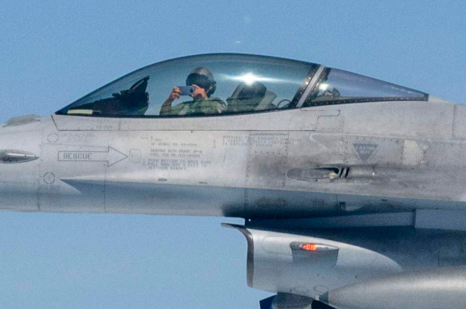 A Polish pilot seen taking a snap of the Airbus with his smartphone