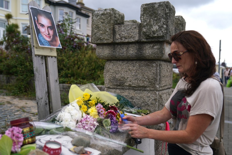 A fan lights a candle at a shrine honouring the music legend in Ireland