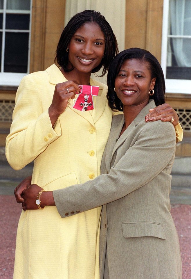 Olympic athlete Dame Denise Lewis with her mother Joan at Buckingham Palace