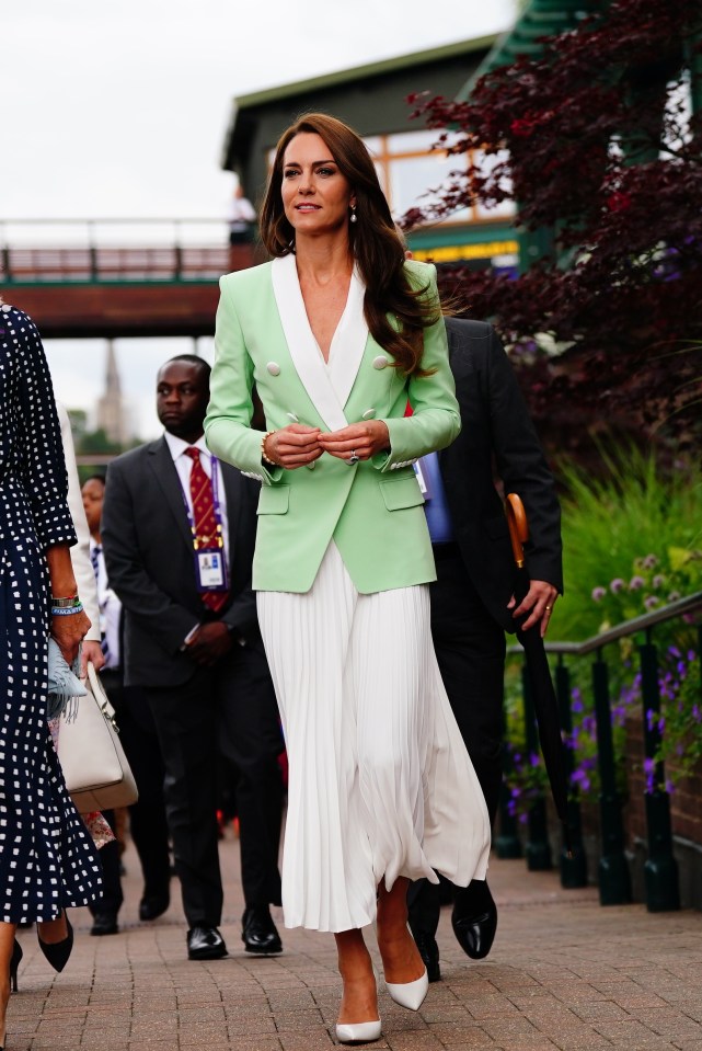 Kate wore a £1,950 green Balmain blazer and white skirt