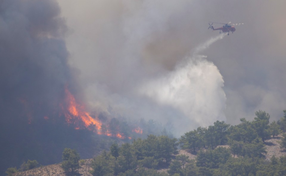 Choppers drop bombs of water on raging fires near Lindos on Rhodes