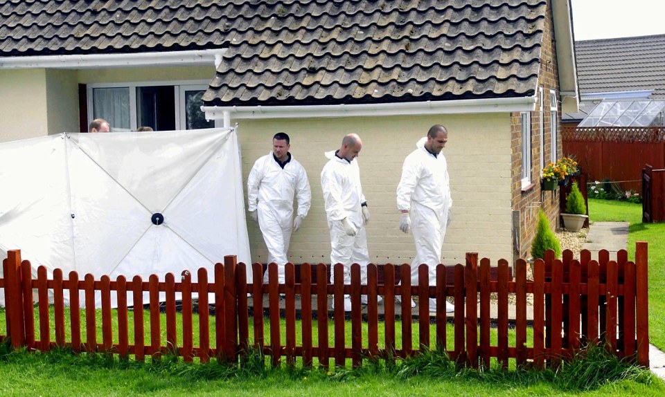 Forensic officers inspect the crime scene after the double murder of Joan Strirland and her husband John