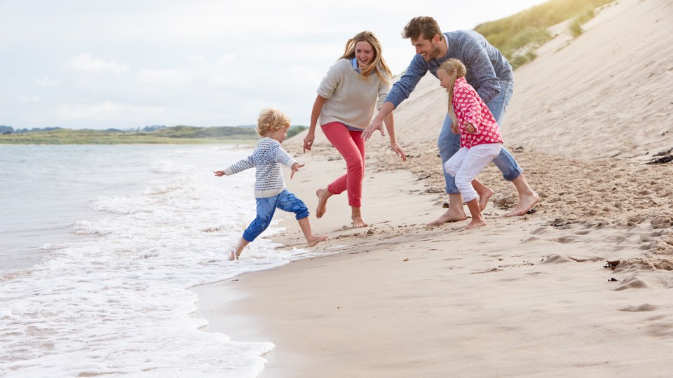 Family On Beach Vacation Playing By Sea; Shutterstock ID 376921243; purchase_order: -; job: -; client: -; other: -