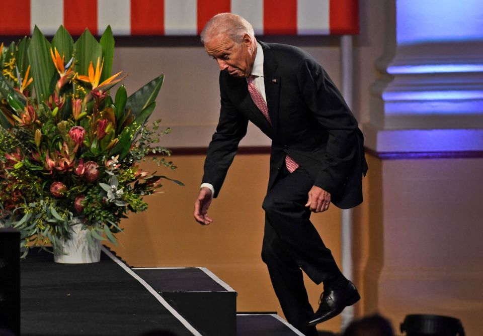 The US President pictured tripping over as he walks onto a stage