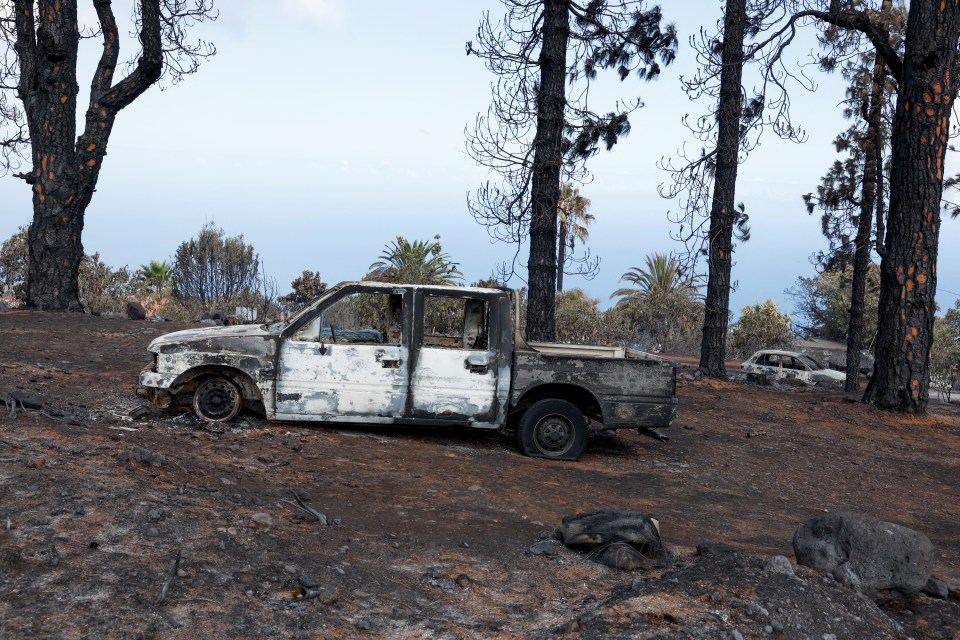 Burnt out cars are visible in the heat-ravaged Spanish island of La Palma