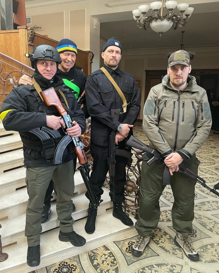 Usyk, centre, holds a machine gun as he joins his country efforts to thwart Vladimir Putin’s Russian invaders