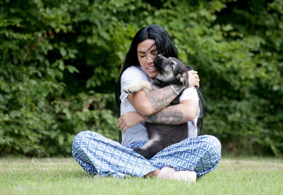 Katie Price has been pictured cuddling her new puppy after being blasted by an animal charity