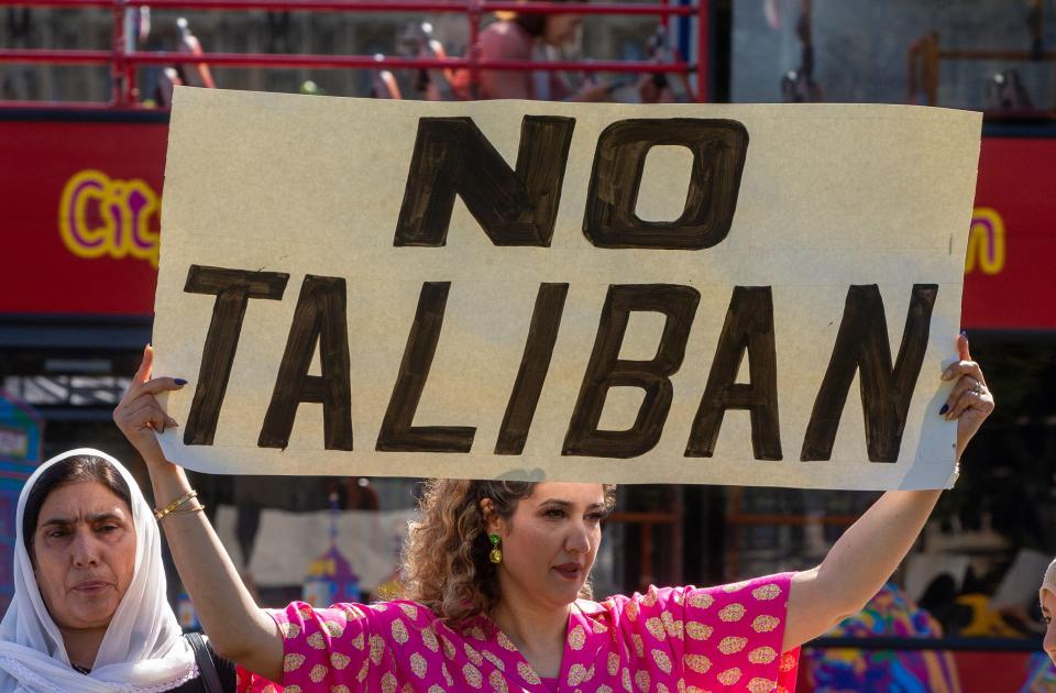 Protestor Sadaf holds a banner in London earlier this month