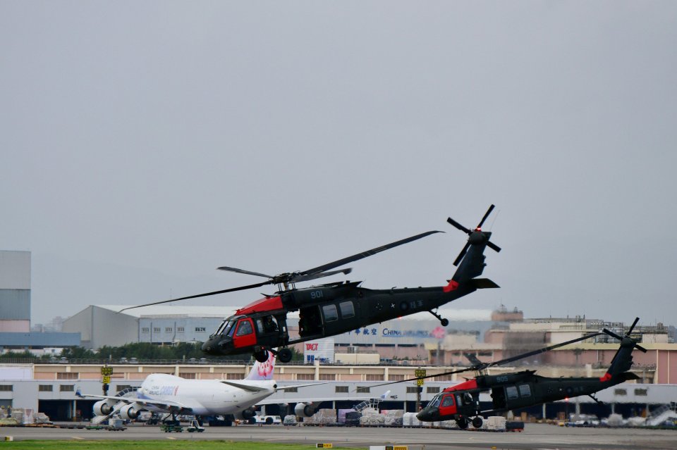 Military helicopters taking off from an airport