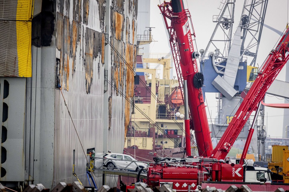 The salvageable cars being unloaded slowly from the belly of the ship