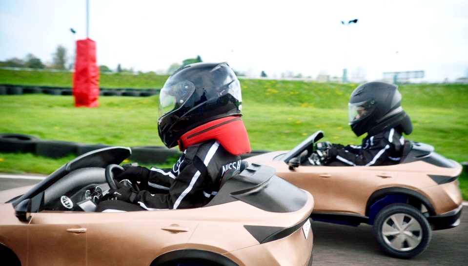 A group of lucky children raced mini electric cars watched by professional drivers