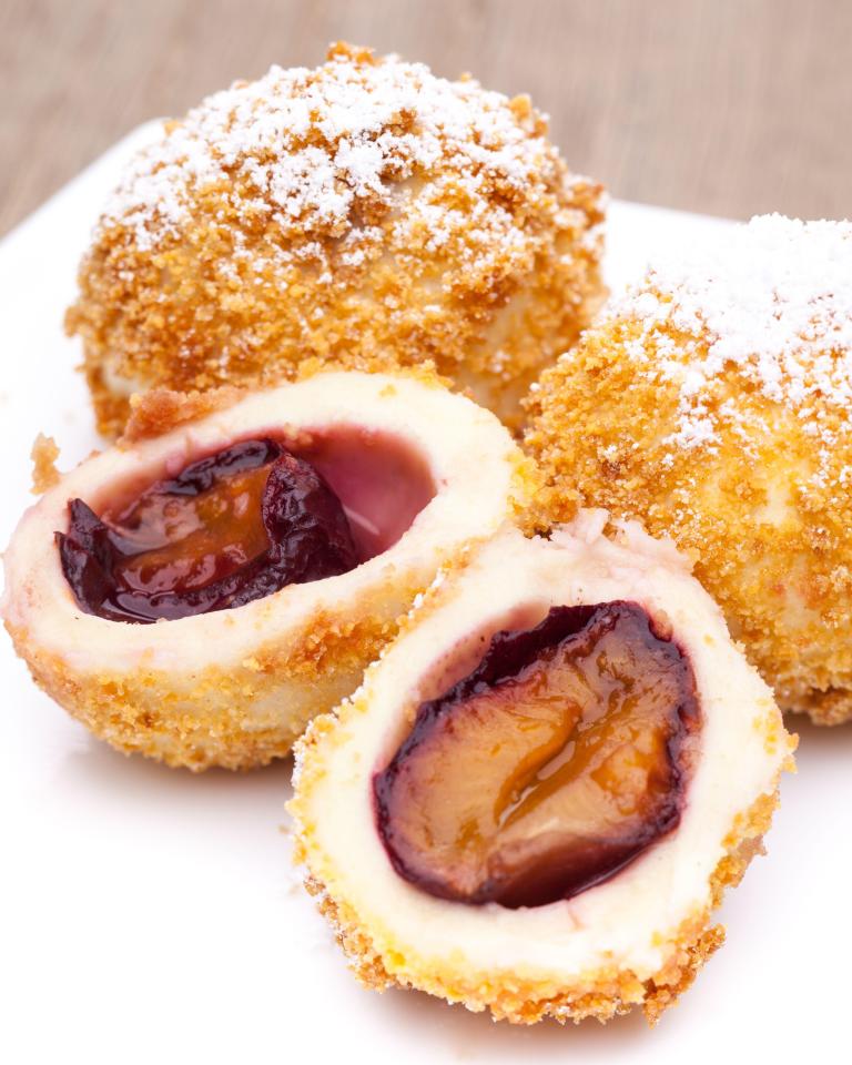 Plum dumplings coated in butter and sugar