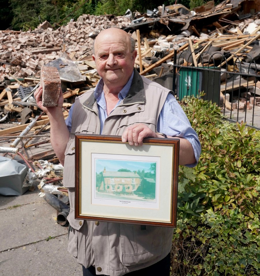 Joe Harvey with a keepsake brick and a painting of the pub which hangs in his house, said: 'There’s no going back for the place'