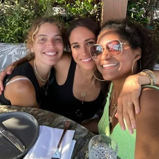 Meghan Markle yesterday posed for a selfie with pals over an al-fresco lunch