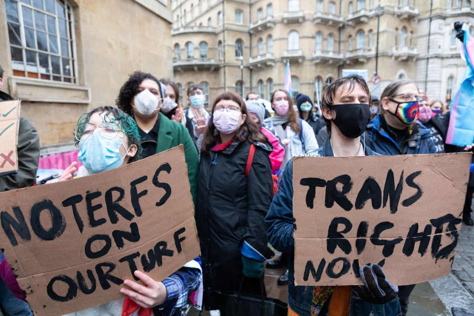 LONDON, UNITED KINGDOM - 2022/01/08: Protestors hold placards saying 'no terfs on our turf' and 'trans rights now' during the demonstration.<br />
Organized by Trans Activism UK, transgender rights supporters gathered outside BBC's office at Portland Place to protest against the news corporation's queerphobic agenda. Earlier in October 2021, the BBC published an article titled 'We're being pressured into sex by some trans women', which sparked widespread outrage among the transgender community. The group gathered to condemn BBC for spreading hatred and discrimination against the transgender population. (Photo by Belinda Jiao/SOPA Images/LightRocket via Getty Images)