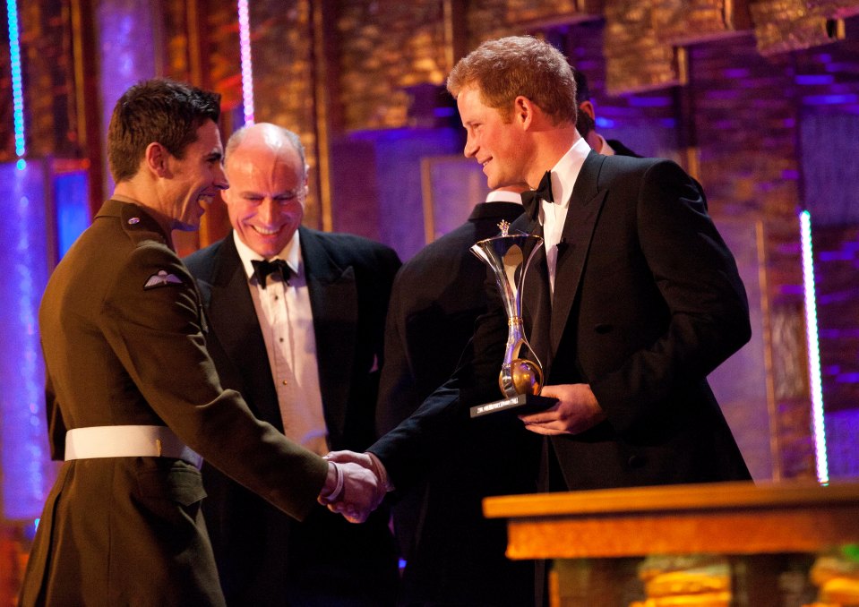 The Sun Military Awards  ( Millies ) at The Imperial War Museum  December 19, 2011 in London. Prince Harry presents the  Support to the armed forces award to Walking with the wounded, to Private Jaco Van Gass 19.12.2011 PICTURE BY LEE THOMPSON