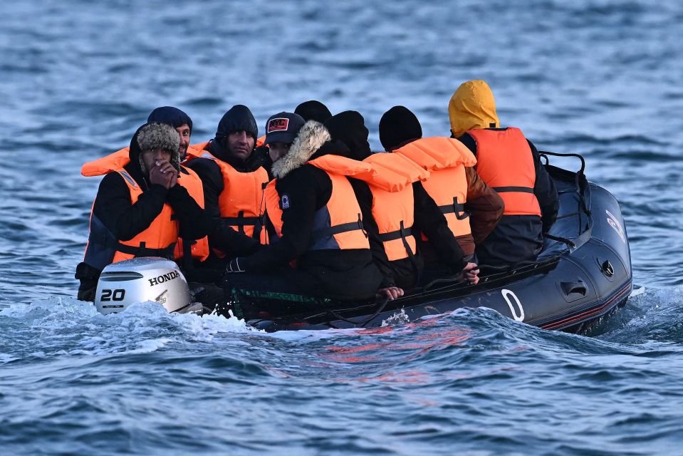 Migrants travel in an inflatable boat across the English Channel, bound for Dover on the south coast of England. - More than 45,000 migrants arrived in the UK last year by crossing the English Channel on small boats. (Photo by Ben Stansall / AFP) (Photo by BEN STANSALL/AFP via Getty Images)