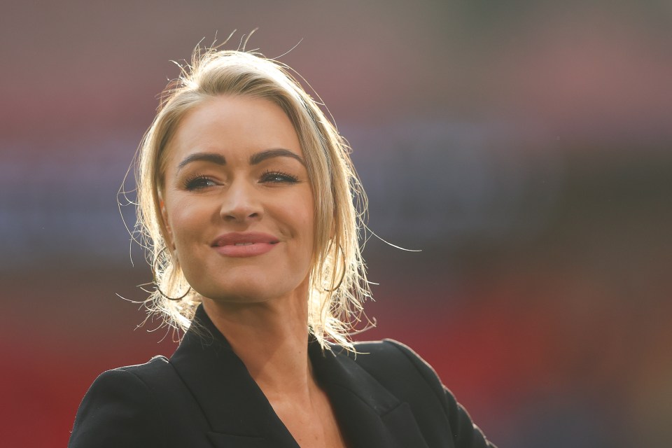 a woman with blonde hair wearing a black jacket