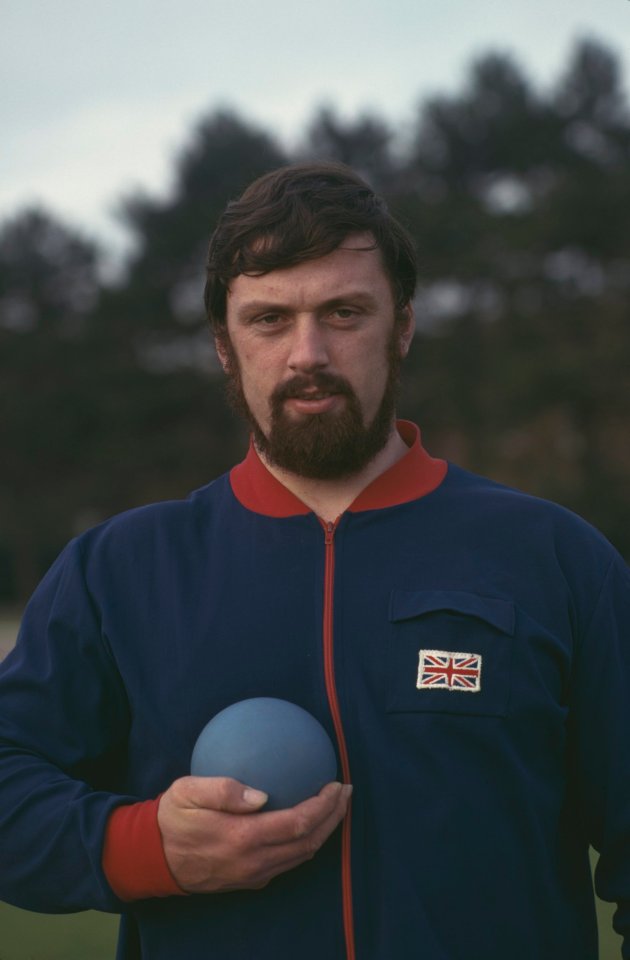 Geoff Capes holding a shot put.