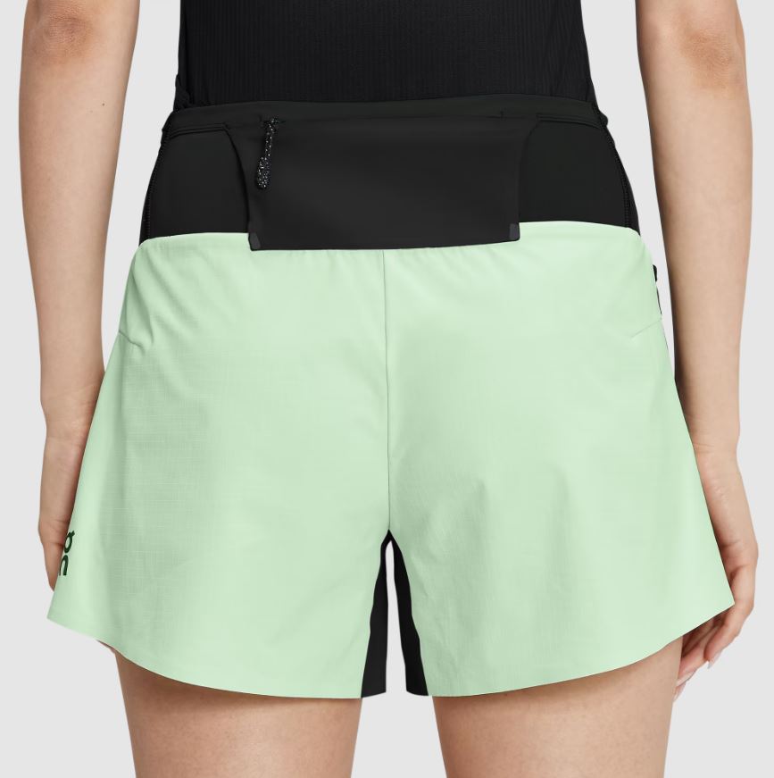 Light green running shorts with a black waistband.