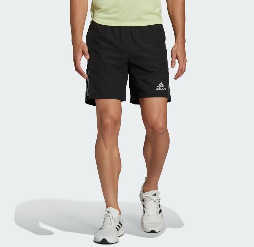 Man wearing black Adidas running shorts.