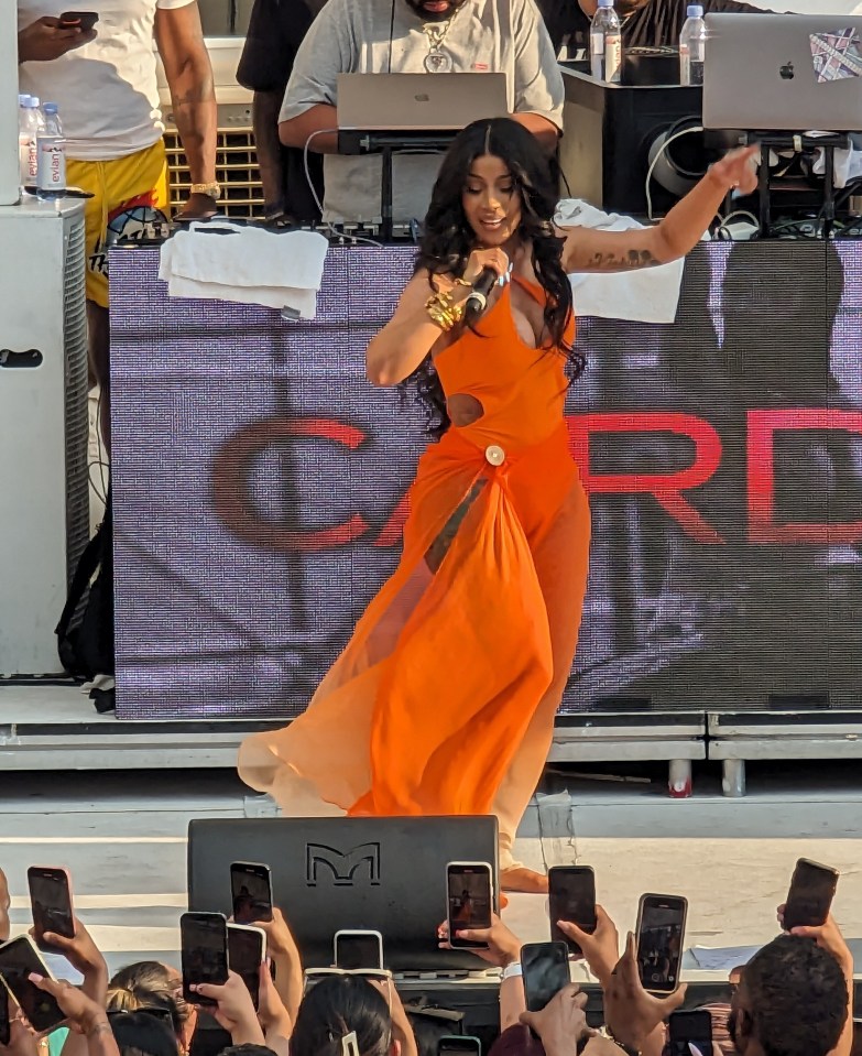 Cardi B stuns in flowing orange swim cover up as she performs her hits 2 hrs late as fans waited in 112 degree heat during fight weekend in Las Vegas. The rap star even asked fans to actually throw water on her private area (heard in video to follow) as the crowd threw bottled water as she sang and complained about the excessive heat in Sin City. Pictured: Cardi B Ref: SPL9653290 290723 NON-EXCLUSIVE Picture by: Brian Prahl / SplashNews.com Splash News and Pictures USA: 310-525-5808 UK: 020 8126 1009 eamteam@shutterstock.com World Rights,