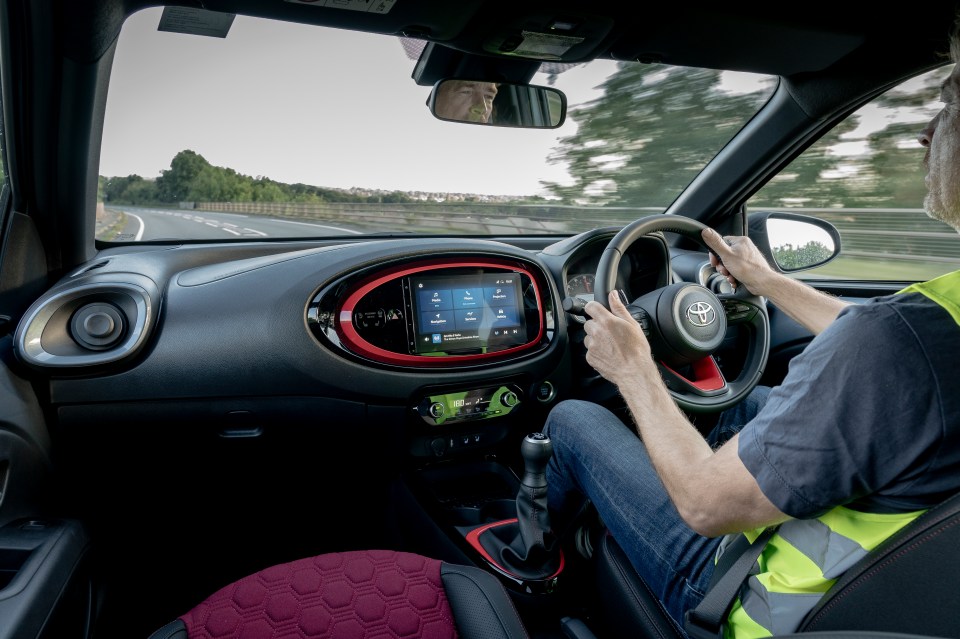 The cherry-red seats look really expensive, and the matching touch-screen surround looks smart