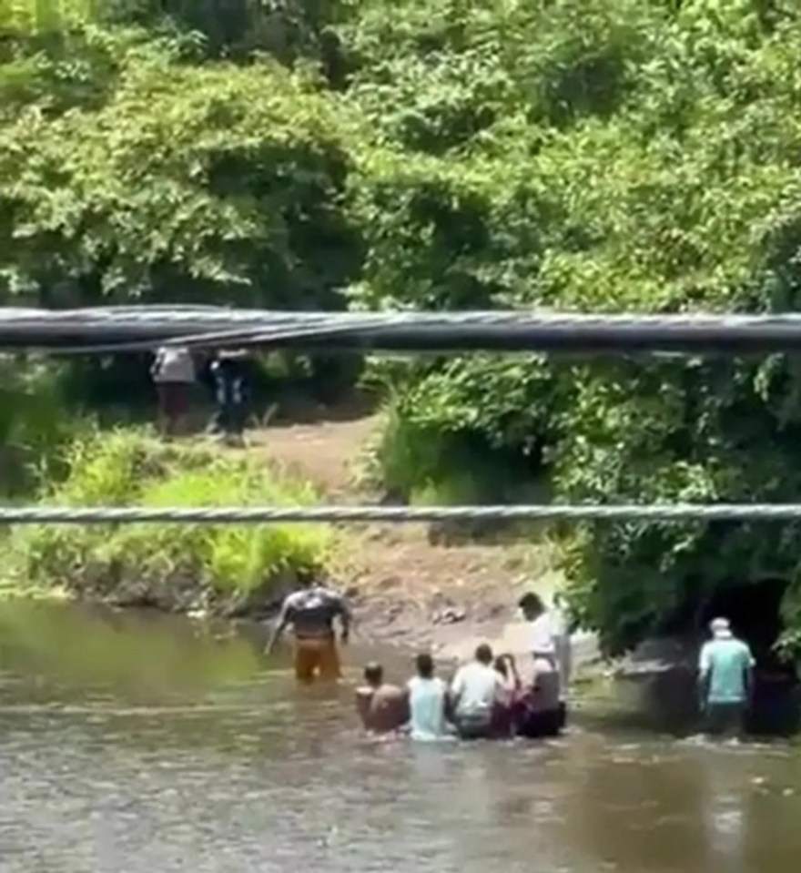 Locals battled to haul the victim's body from the river