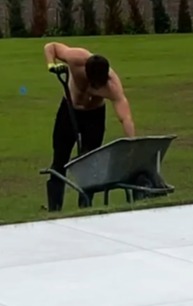 Mark displayed his ripped physique while using a wheelbarrow