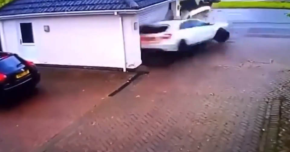 The car slammed into the garage with immense force, spun around and sent bricks flying