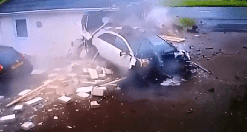 Footage shows the smoking wreckage of the car after it careened into the garage