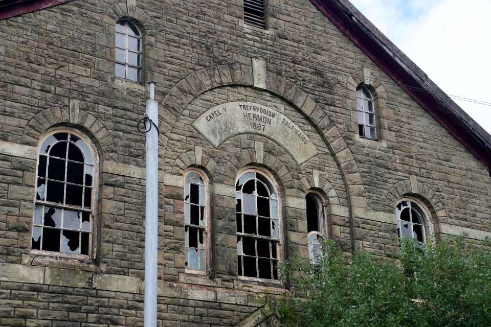 A derelict chapel with multiple broken windows