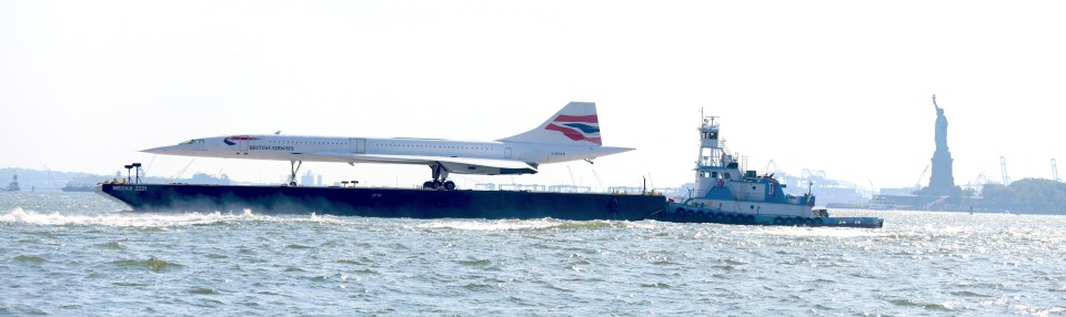 The supersonic jet floats past the iconic Statue of Liberty