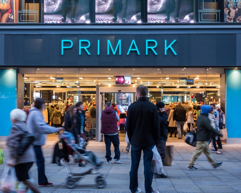 people are walking in front of a store called primark