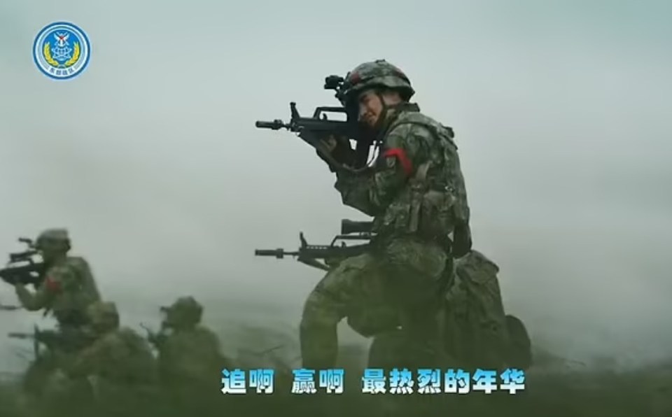 Soldiers in full combat gear can be seen storming a beach