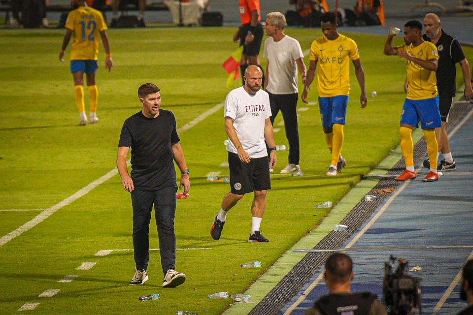 Gerrard braved the heat - pacing in a black t-shirt and tracksuit bottoms