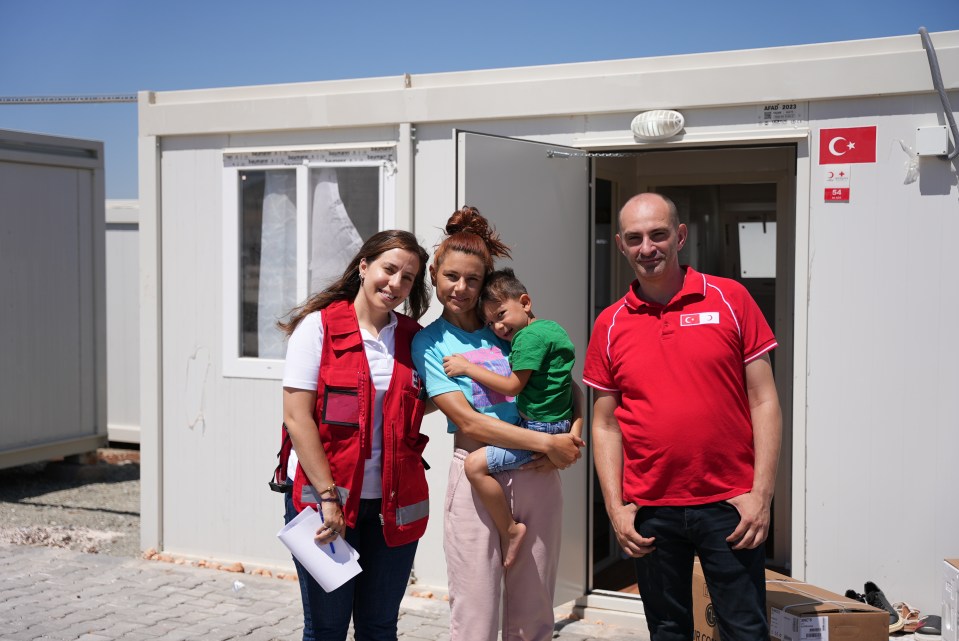 Selver Erpirti and her son Talha at container home with volunteers