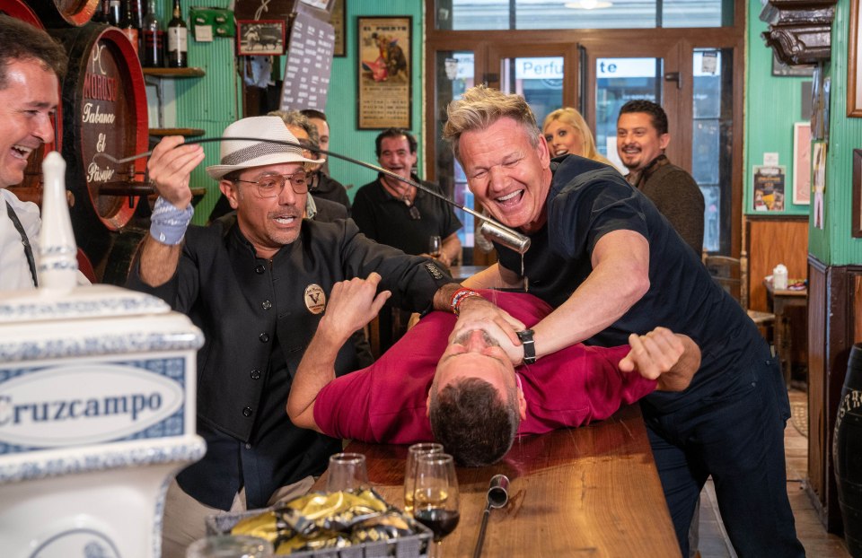 Gordon Ramsay, Fred Sirieix and Gino D'Acampo tried drinking local sherry in Spain - with Gino pouring it into Fred’s mouth on a bar top