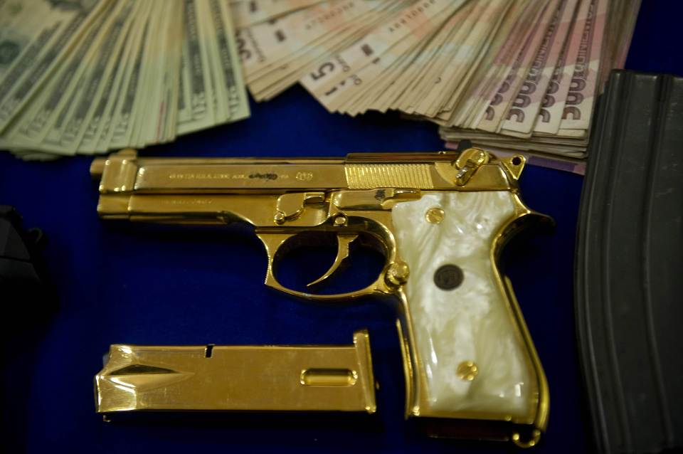 His flash henchmen wielded handguns covered with gold