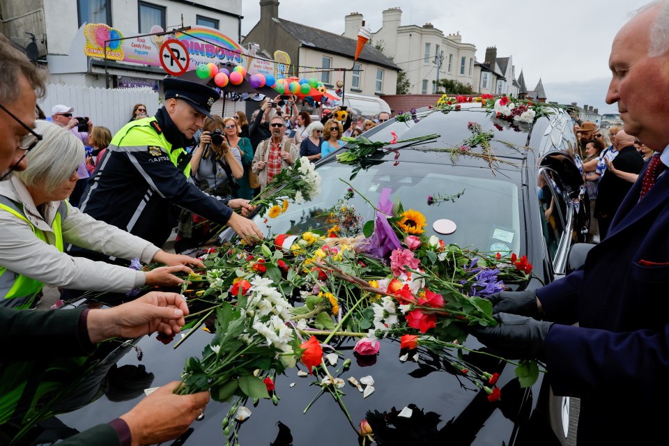 The emotion was palpable as flowers were placed on the hearse