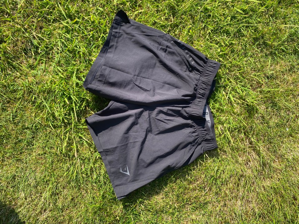 Black gym shorts on the grass.