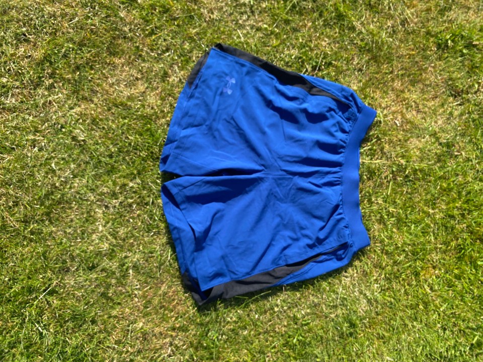 Blue athletic shorts on the grass.