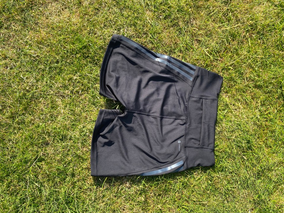 Black athletic shorts on grass.