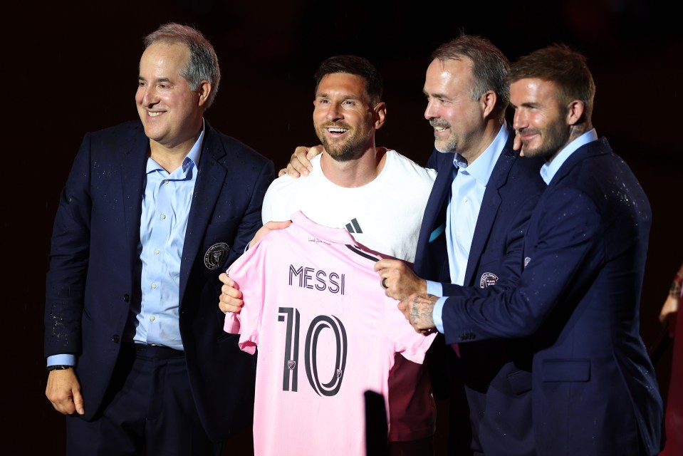 Inter Miami owners Jorge Mas, Jose Mas, and David Beckham pose alongside Lionel Messi at his unveiling