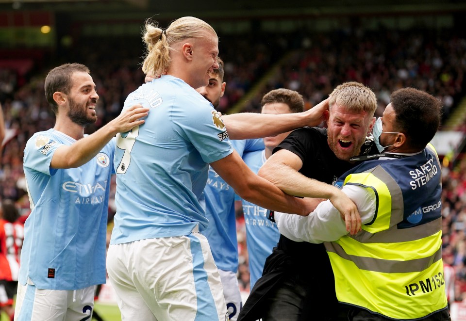 A former world champion boxer jumped on Man City star Erling Haaland before being removed by security