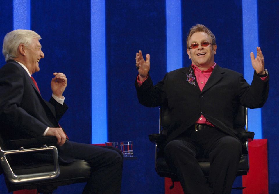 Parkinson is seen interviewing Elton John