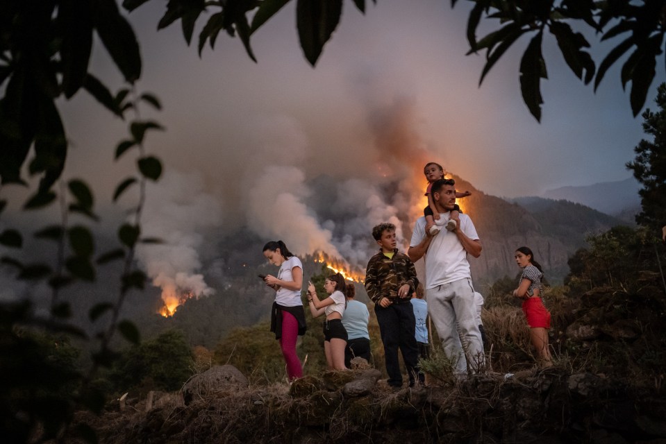 Neighbours have tried to protect their homes before being evacuated