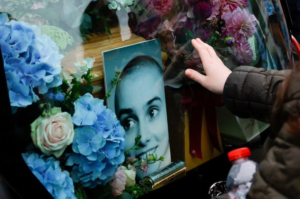 The cortege featured a picture of Sinead and stunning blue flowers